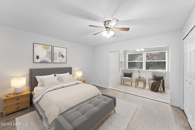 bedroom with light hardwood / wood-style flooring, a closet, and ceiling fan