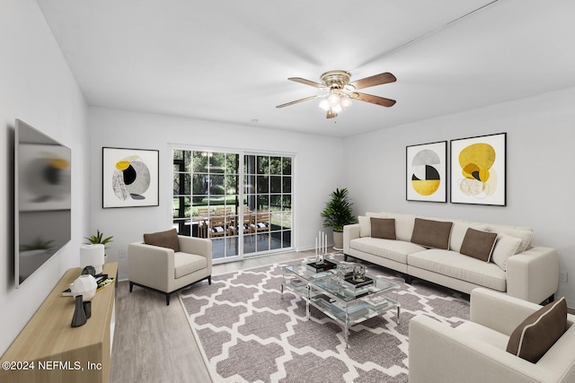 living room with hardwood / wood-style floors and ceiling fan