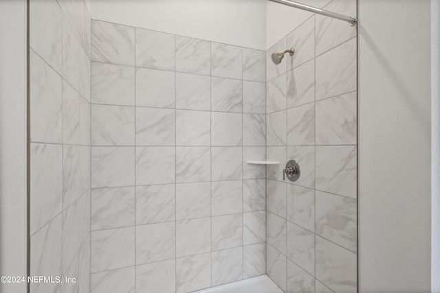 bathroom with a tile shower