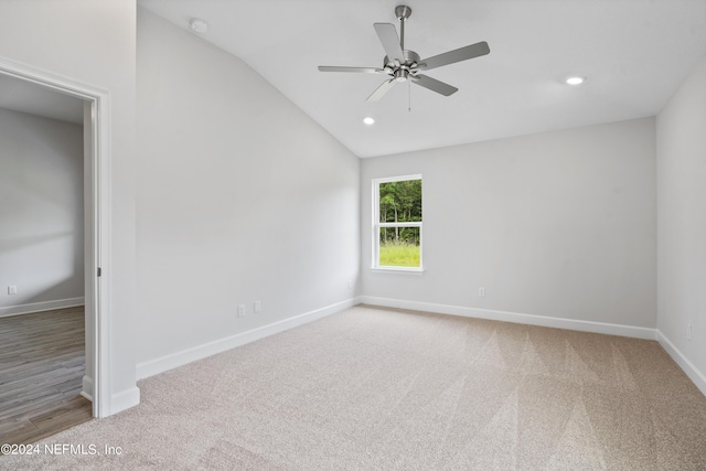 unfurnished room with vaulted ceiling, carpet flooring, and ceiling fan