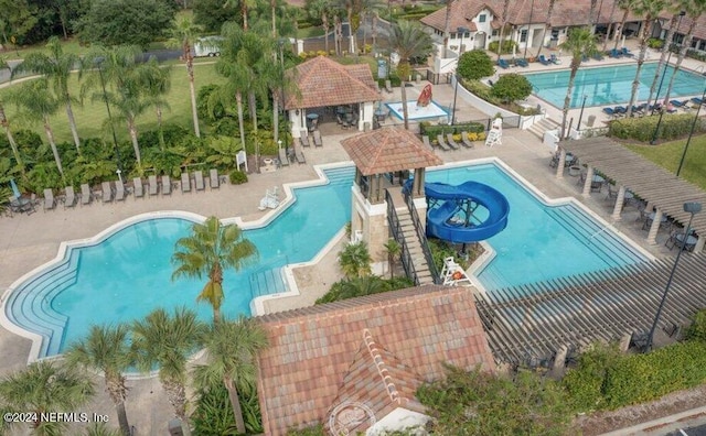 view of pool featuring a gazebo, a patio, and a water slide