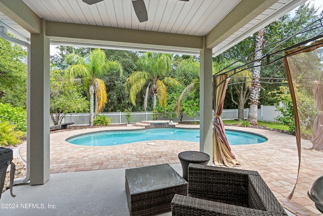 view of swimming pool with ceiling fan and a patio