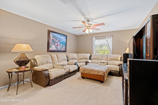 carpeted living room featuring a textured ceiling and ceiling fan