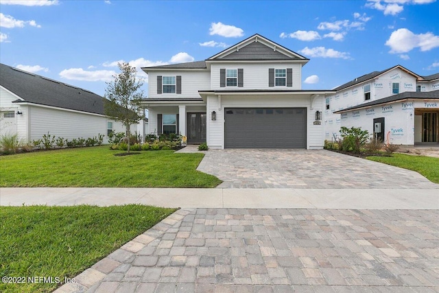 view of front of house featuring a front lawn and a garage