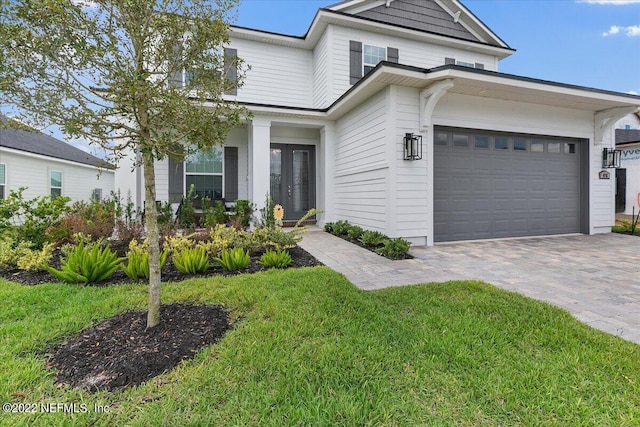 view of front of home featuring a garage and a front yard