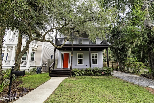 view of front of home featuring a balcony and a front lawn