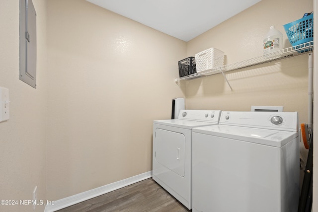 laundry room with independent washer and dryer and dark wood-type flooring