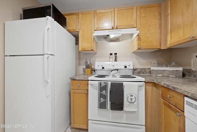 kitchen featuring light brown cabinetry and white appliances