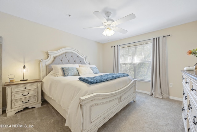 bedroom with ceiling fan and light carpet