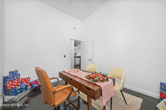 dining area featuring high vaulted ceiling