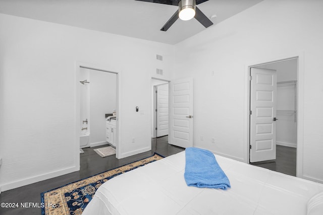 bedroom with ensuite bathroom, a spacious closet, and ceiling fan