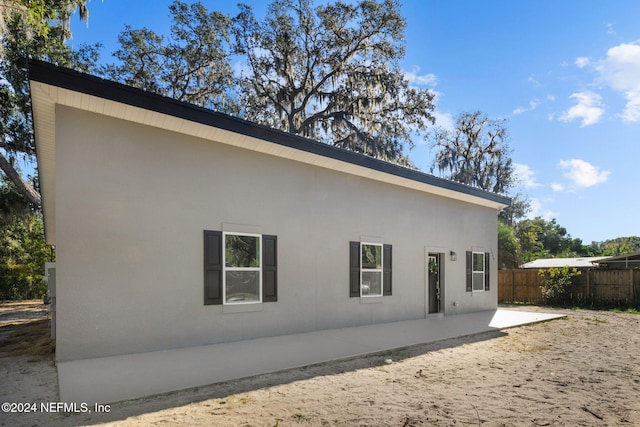 view of side of property with a patio