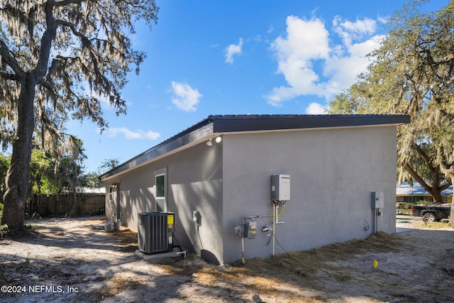 view of property exterior featuring central AC