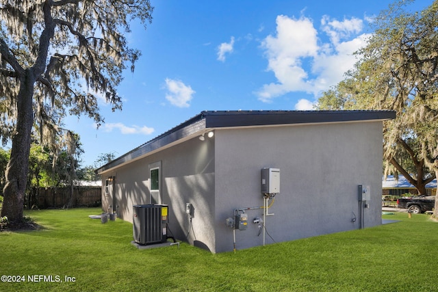 view of property exterior featuring a lawn and central air condition unit