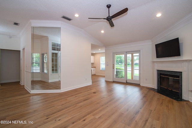 unfurnished living room featuring a textured ceiling, hardwood / wood-style floors, ceiling fan, crown molding, and a premium fireplace