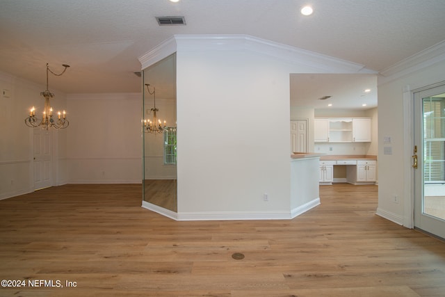 interior space with crown molding, light wood-type flooring, a textured ceiling, and a chandelier