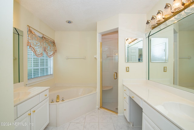 bathroom featuring vanity, shower with separate bathtub, and a textured ceiling