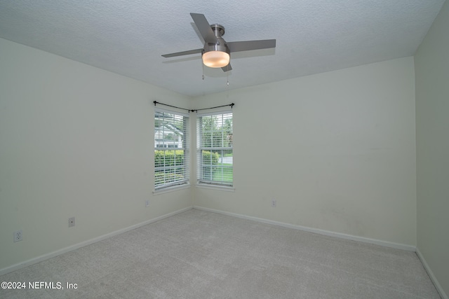 spare room featuring ceiling fan, a textured ceiling, and carpet floors