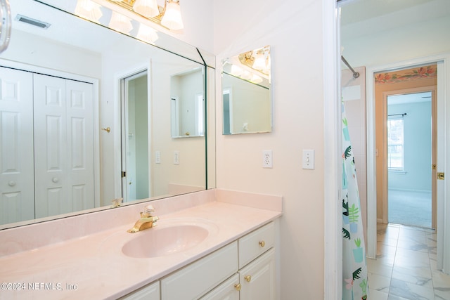 bathroom with vanity and tile patterned flooring