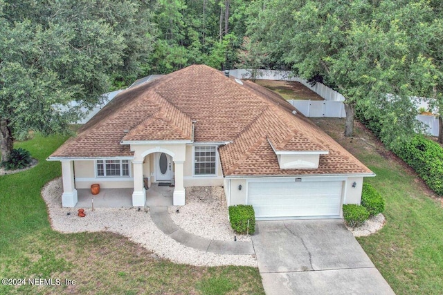 view of front of property with a garage and a front lawn