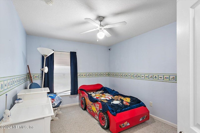 carpeted bedroom with ceiling fan and a textured ceiling