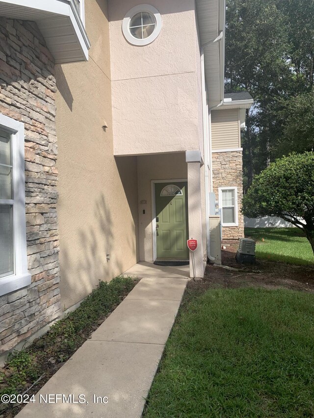 doorway to property featuring central AC unit