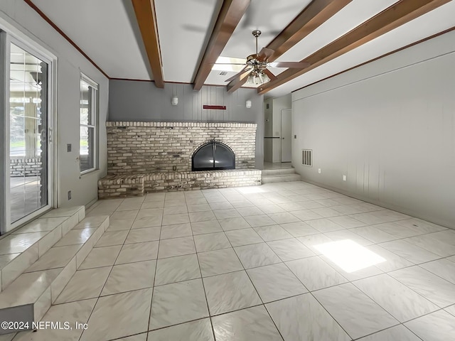 unfurnished living room with visible vents, ceiling fan, a fireplace, beam ceiling, and light tile patterned flooring