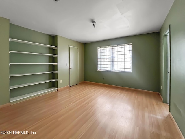 unfurnished bedroom featuring baseboards and wood finished floors