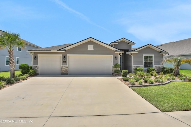 view of front of house with a garage and a front lawn