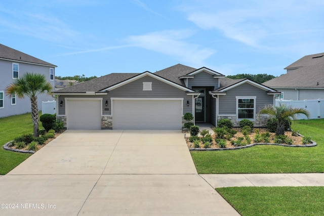 view of front facade featuring a garage and a front lawn