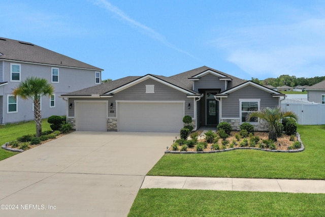 view of front facade with a garage and a front lawn