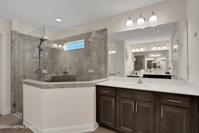 bathroom with a shower with door and vanity