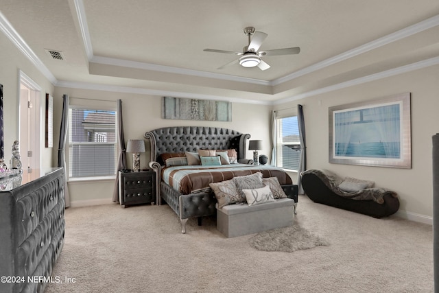 bedroom with ceiling fan, carpet flooring, ornamental molding, and a tray ceiling