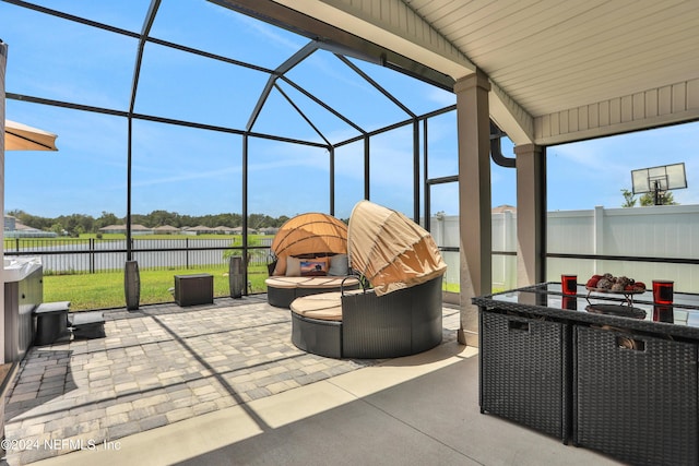 view of patio featuring glass enclosure