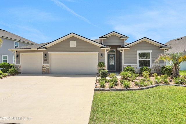 view of front of property with a garage and a front lawn