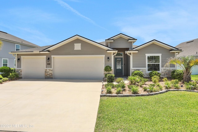 view of front of property with a garage and a front yard