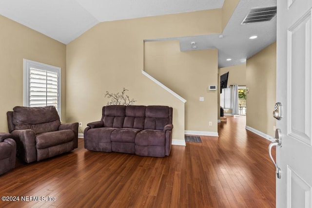 living room featuring dark hardwood / wood-style flooring and high vaulted ceiling