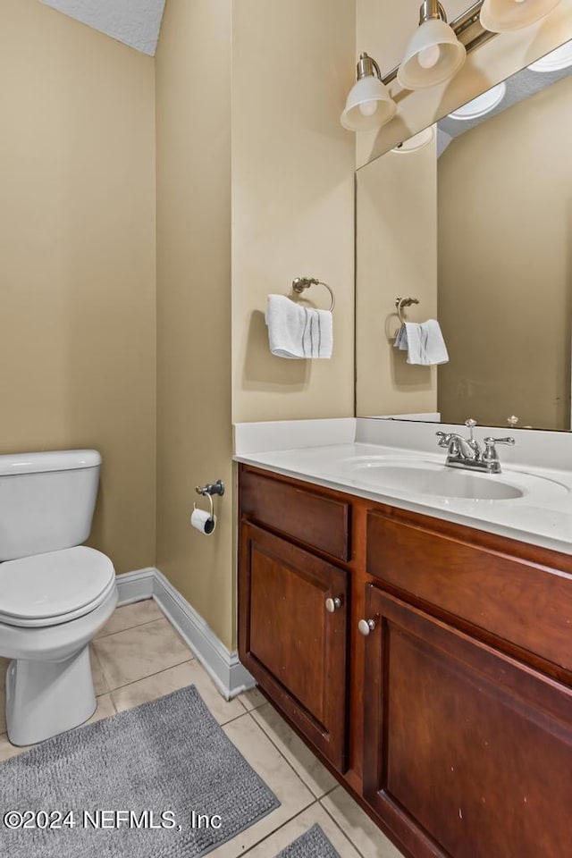 bathroom featuring vanity, toilet, and tile patterned floors