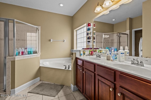 bathroom with tile patterned flooring, shower with separate bathtub, and vanity