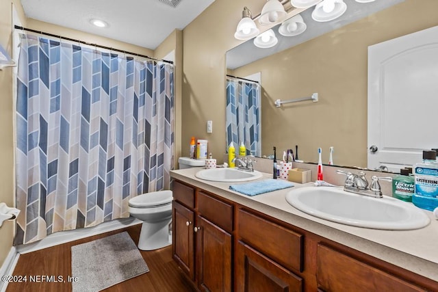 bathroom with a shower with curtain, vanity, toilet, and wood-type flooring