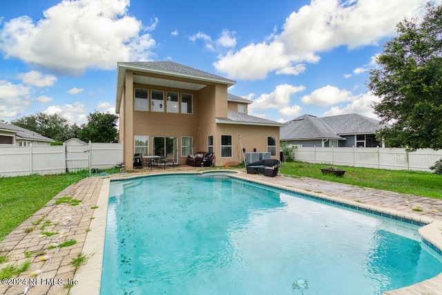 view of pool featuring a lawn and a patio area