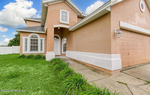 view of front property with a garage and a front lawn