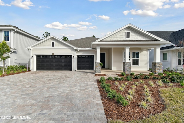 view of front of home featuring a garage and a porch