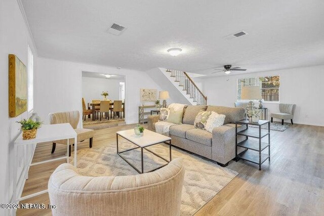 living room featuring ceiling fan and light wood-type flooring