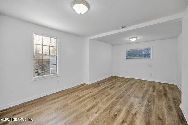 unfurnished room with hardwood / wood-style flooring