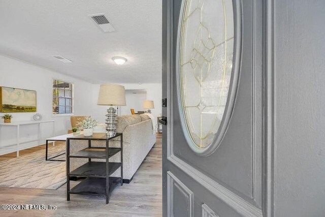 interior space featuring hardwood / wood-style flooring and a textured ceiling