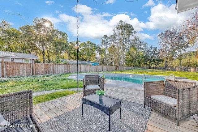 view of swimming pool with a yard and a wooden deck