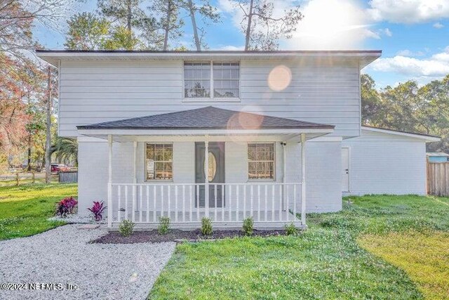 view of front property with a porch and a front lawn