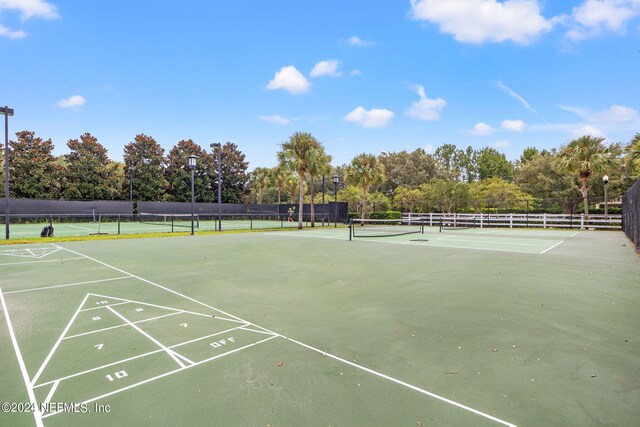 surrounding community with tennis court