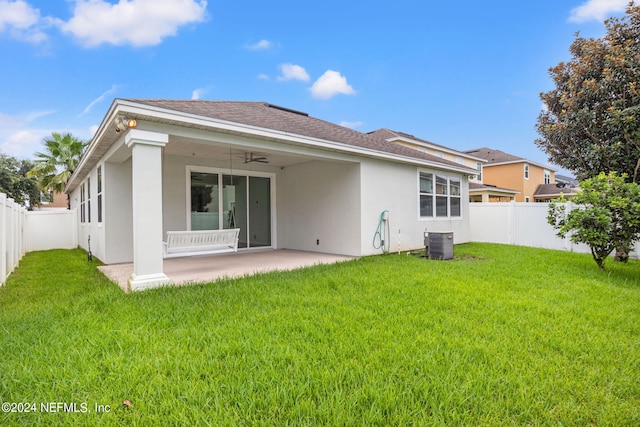 rear view of property featuring a patio, central AC, a lawn, and ceiling fan